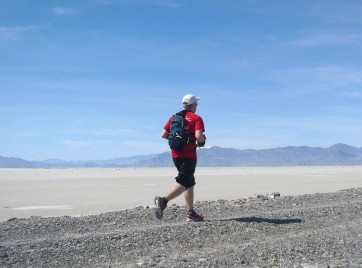 Kevin on dike with salt flats in the distance